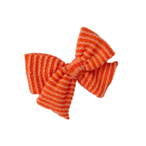 Orange waved rib knit pinwheel bow